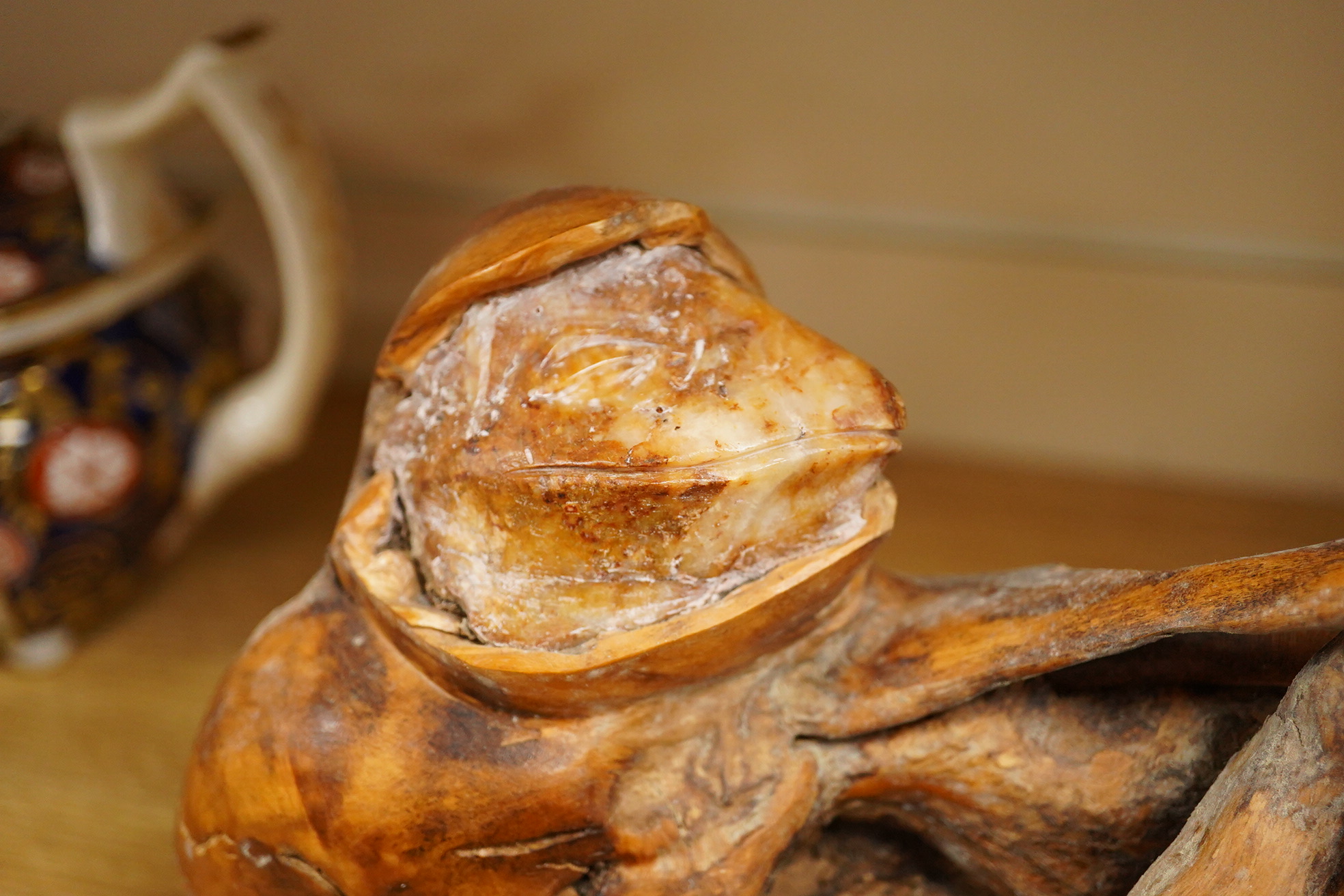 Pierre Decorse (b.1953), a wooden sculpture of a reclining frog-like figure, base 34cms long